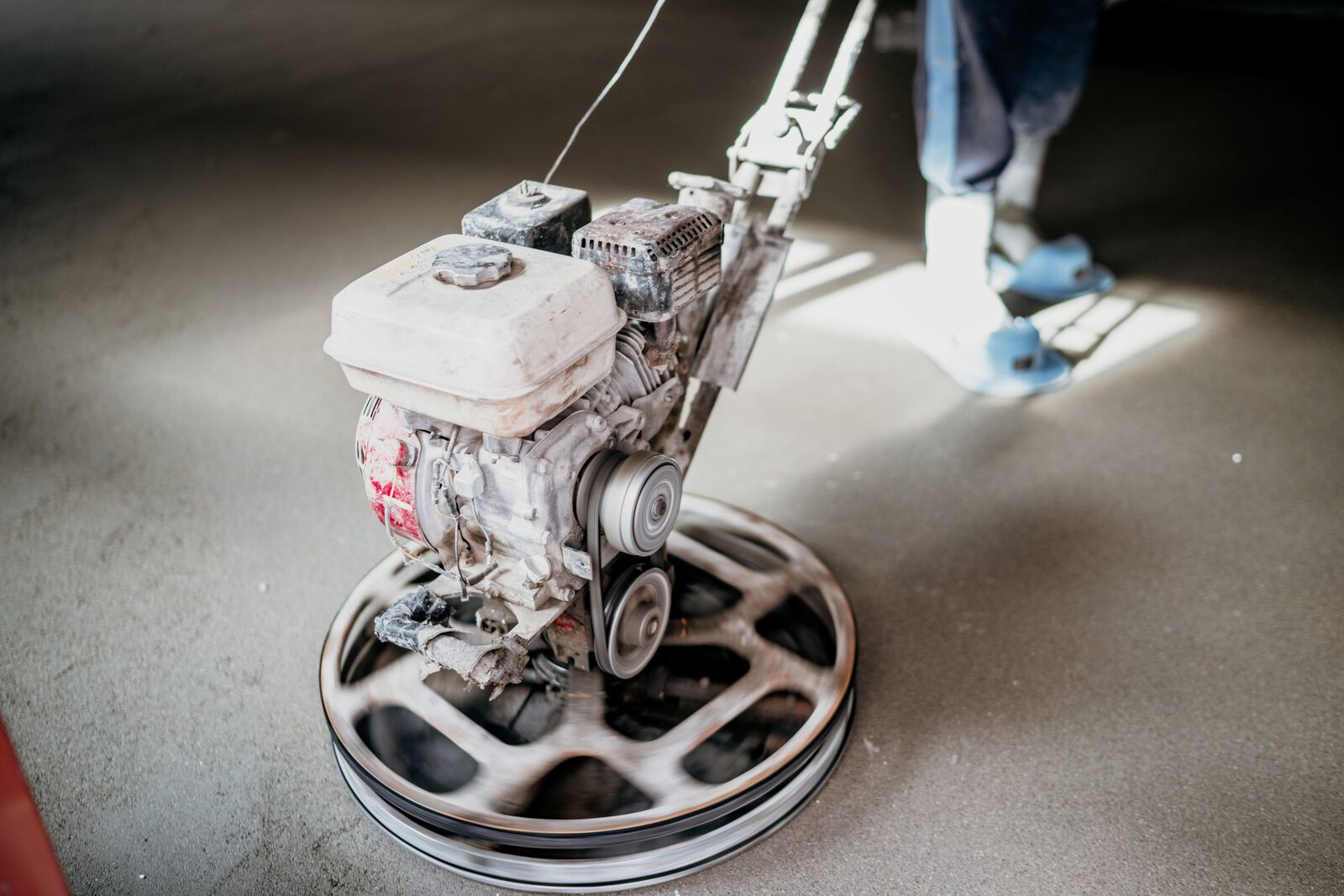 Diamond grinder opening up a concrete slab before coating